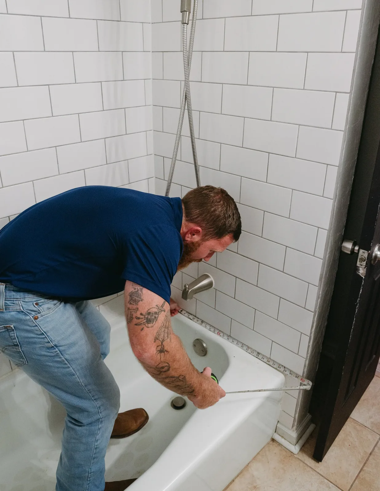 Texas Bath and Shower measuring an existing bathtub during project planning